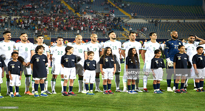 Algeria's players sing their national anthem prior to the 2019 Africa Cup of Nations (CAN) football match between Algeria and Kenya at the 30 June Stadium in Cairo on June 23, 2019. (Photo by Khaled DESOUKI / AFP) (Photo credit should read KHALED DESOUKI/AFP/Getty Images)