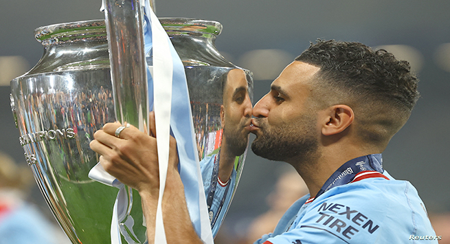 Soccer Football - Champions League Final - Manchester City v Inter Milan - Ataturk Olympic Stadium, Istanbul, Turkey - June 11, 2023 Manchester City's Riyad Mahrez celebrates with the trophy after winning the Champions League REUTERS/Molly Darlington