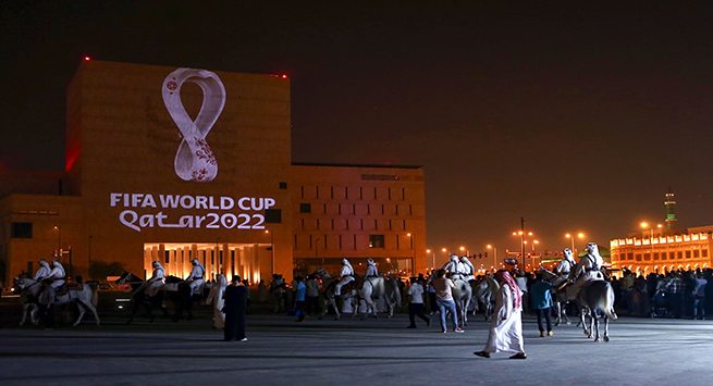 Qataris gather at the capital Doha's traditional Souq Waqif market as the official logo of the FIFA World Cup Qatar 2022 is projected on the front of a building on September 3, 2019. (Photo by - / AFP)        (Photo credit should read -/AFP via Getty Images)